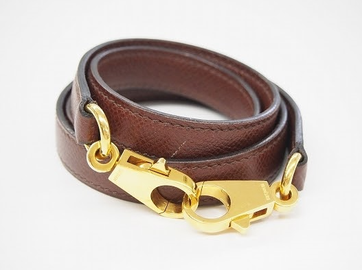 茶色にゴールドの金具がアクセントなエルメス HERMESのバッグ用ショルダーストラップを買取させて頂きました。